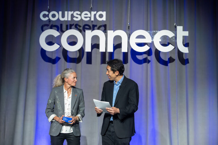 Andrew Ng congratulates a Coursera Partner Award winner