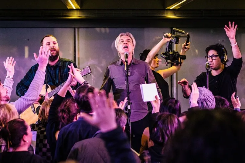 Watch David Byrne Lead a Massive Choir in Singing David Bowie's "Heroes"